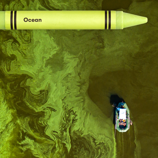 toxic green Crayola crayon with image of polluted water and boat